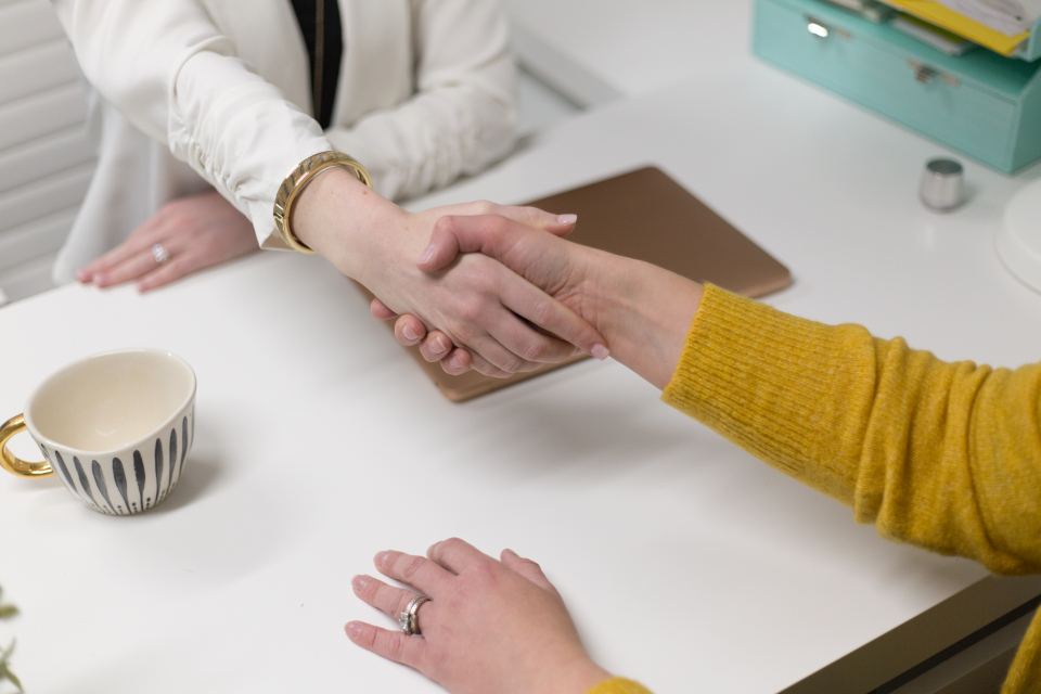 Colleagues agreeing an engagement across a meeting table