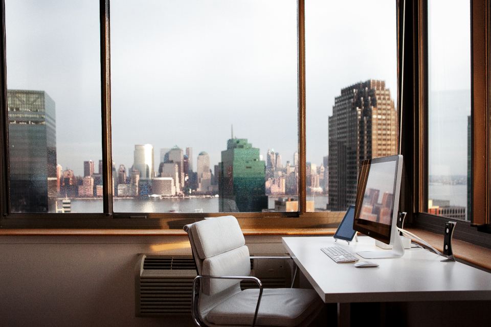 Open-plan corporate office with city view and meeting areas
